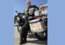 Nick Gilroy and the motorbike he used to travel through all of the states of the USA.
