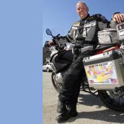 Nick Gilroy and the motorbike he used to travel through all of the states of the USA.