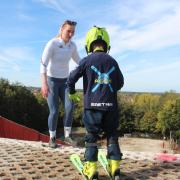 Charlie Guest coaching a junior skier.