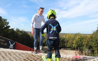 Charlie Guest coaching a junior skier.