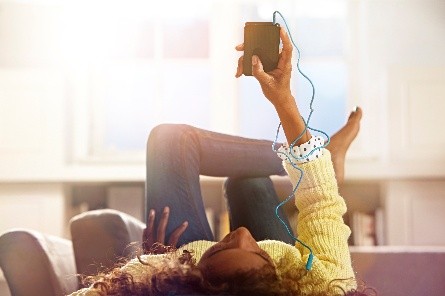 Person using phone with wired headphones