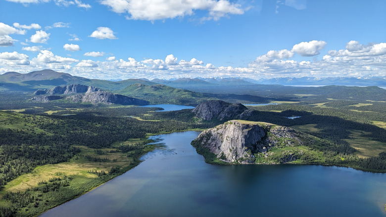 Some of the lakes, hills, and forests of Wood-Tikchik State Park on a clear day, as seen from a mountain