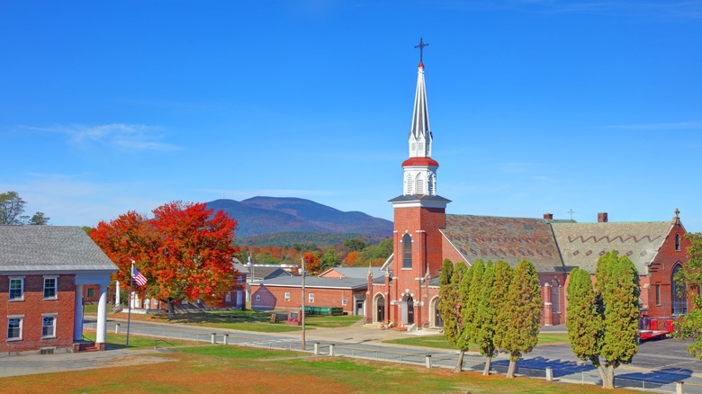 A view of Claremont, New Hampshire, with fall foliage in the foreground and mountains in the background