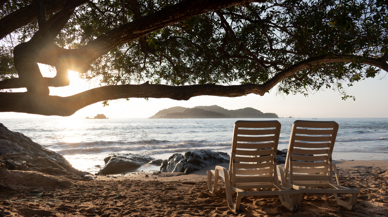 Isla Ixtapa as seen from a beach in Ixtapa, Mexico, with two lounge chairs under a tree