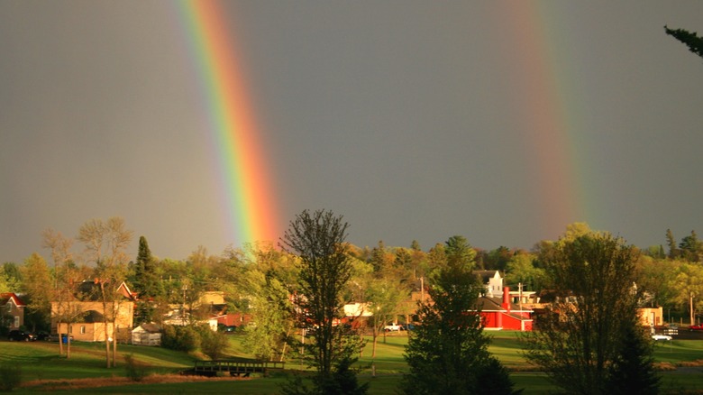 Rainbows over houses and landscapes of Grantsburg, Wisconsin