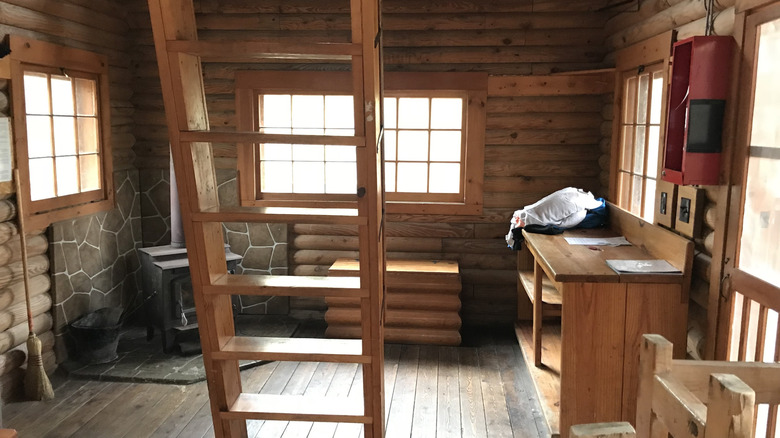 the inside of a simple, rustic log cabin at the Lake of the Ozarks State Park