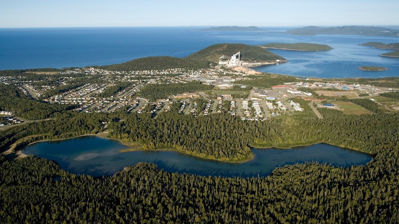 An aerial view of Marathon surrounded by thick forests and Lake Superior