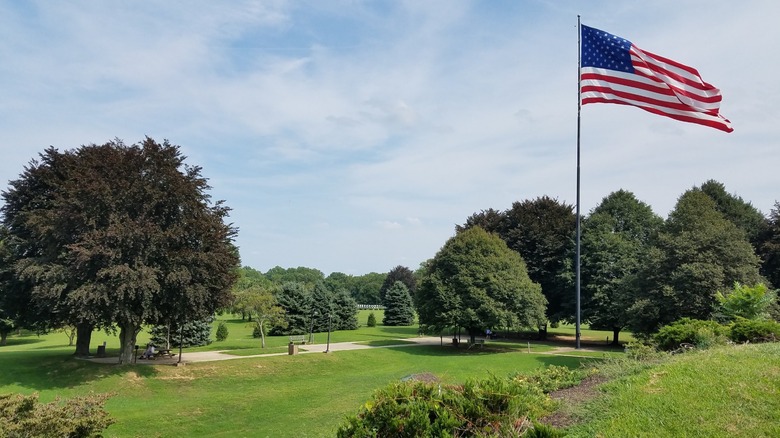 Grassy lawns and trees at Rose Tree County Park, Media, Pennsylvania, with a waving U.S. flag