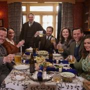 Festive cheer at Skeldale House-  Callum Woodhouse as Tristan Farnon, Anna Madeley as Mrs Hall, Tony Pitts as Richard Alderson, Samuel West as Siegfried Farnon, Imogen Clawson as Jenny Alderson, Nicholas Ralph as James Herriot and Rachel Shenton as Helen