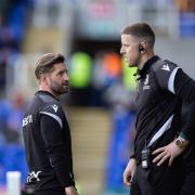 Mark Trueman has a touchline conference with Colin Doyle