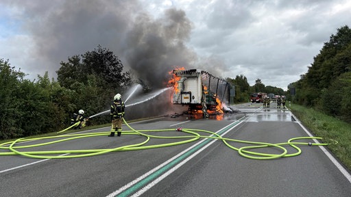 Ein brennender Lkw wird von der Feuerwehr gelöscht.