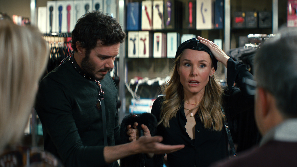 Adam Brody as Noah and Kristin Bell as Joanne show embarassed expressions in a sex shop in Season 1 of 'Nobody Wants This'