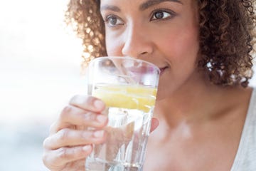 Mid adult woman drinking water Mid adult woman drinking water