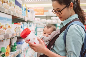 Mom shopping baby food with baby joyfully Mom shopping baby food with baby joyfully