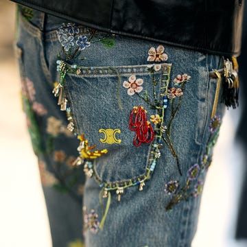 denim jeans with colorful floral embroidery and bead details. denim jeans with colorful floral embroidery and bead details.