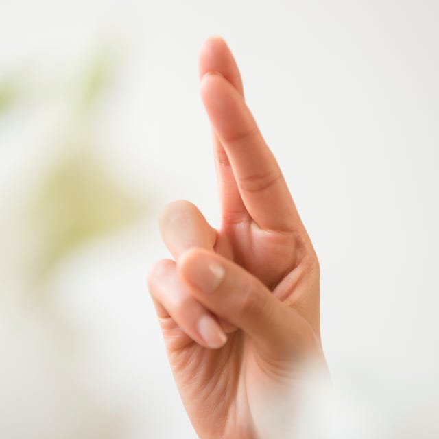 Hand of Hispanic woman with fingers crossed Hand of Hispanic woman with fingers crossed