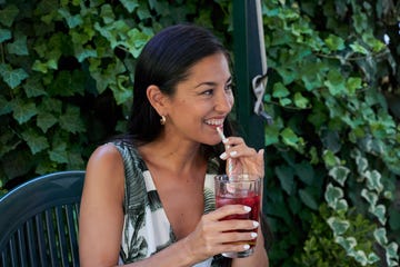 close-up shot of a woman enjoying raspberry syrup tart cherry juice benefits - close-up shot of a woman enjoying raspberry syrup