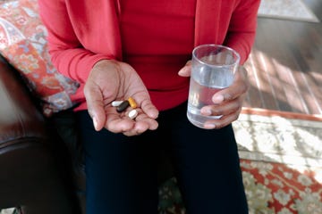 Woman Takes Her Daily Dose of Pills Woman Takes Her Daily Dose of Pills