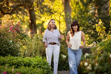 Mature Latin American women friends enjoying the afternoon in a blooming garden Mature Latin American women friends enjoying the afternoon in a blooming garden