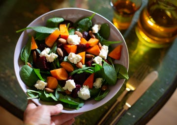 Spinach salad with kaki, beetroot, almonds and gorgonzola cheese low-carb diet