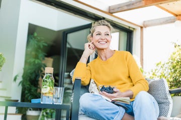 Portrait of happy mature woman relaxing on terrace Portrait of happy mature woman relaxing on terrace