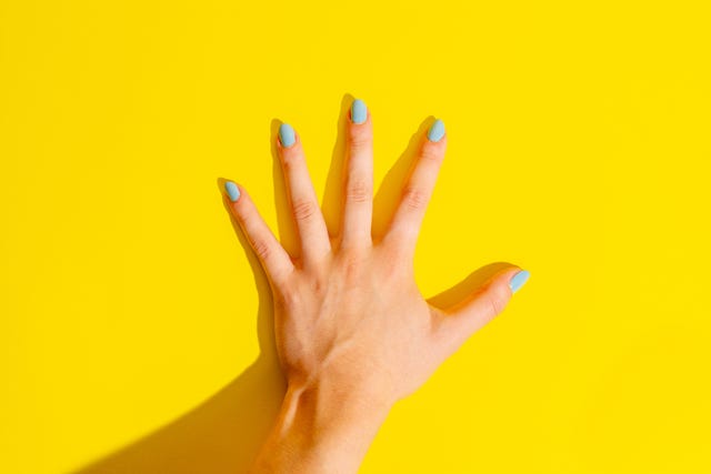 Female Hand on Yellow Background Female Hand on Yellow Background