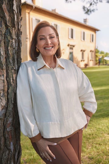 laura geller laura geller leaning against a tree in front of a villa