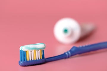 Tooth paste close up on pink background causes of bad breath