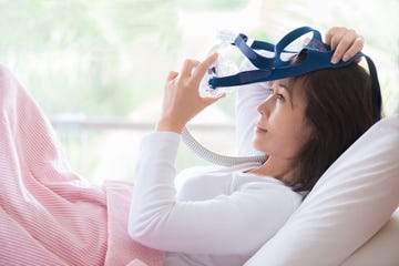 Woman lay in bed wearing CPAP mask ,sleep apnea therapy woman lay in bed wearing cpap mask ,sleep apnea therapy