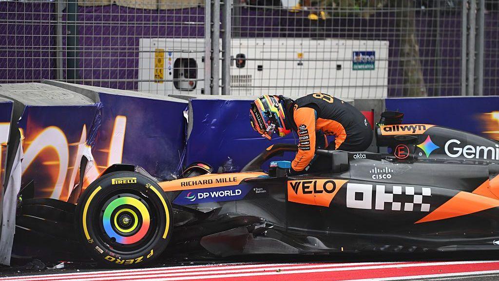 Oscar Piastri adjusts his steering wheel after climbing out of his crashed McLaren in the 2025 Azerbaijan Grand Prix
