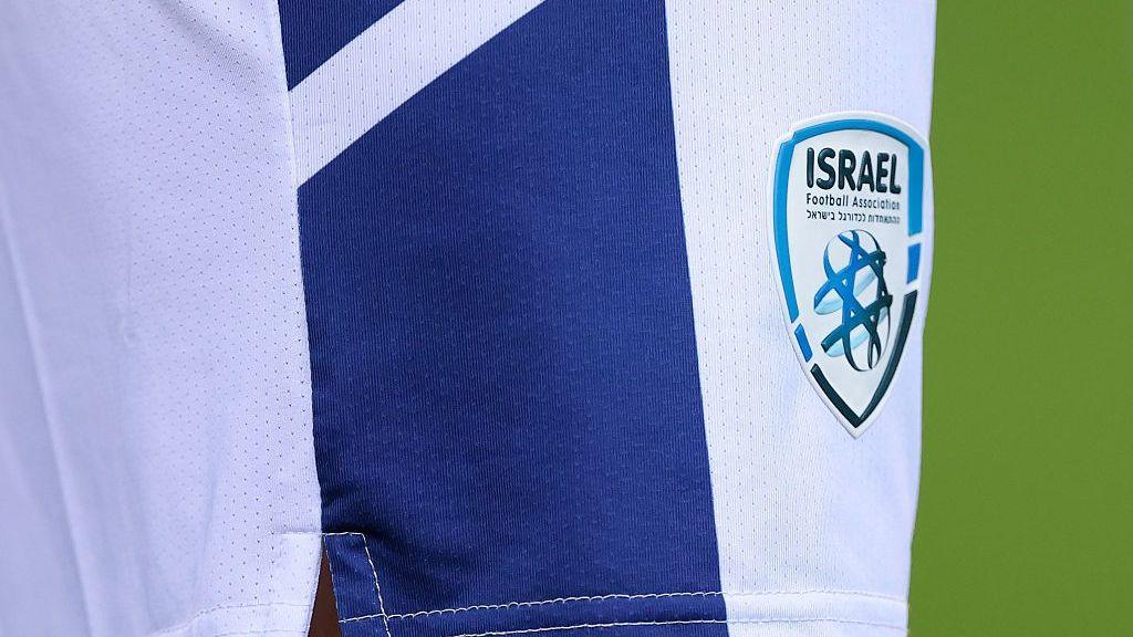 A close-up shot of the badge of the Israel Football Association on the shorts of a national team player during an international fixture