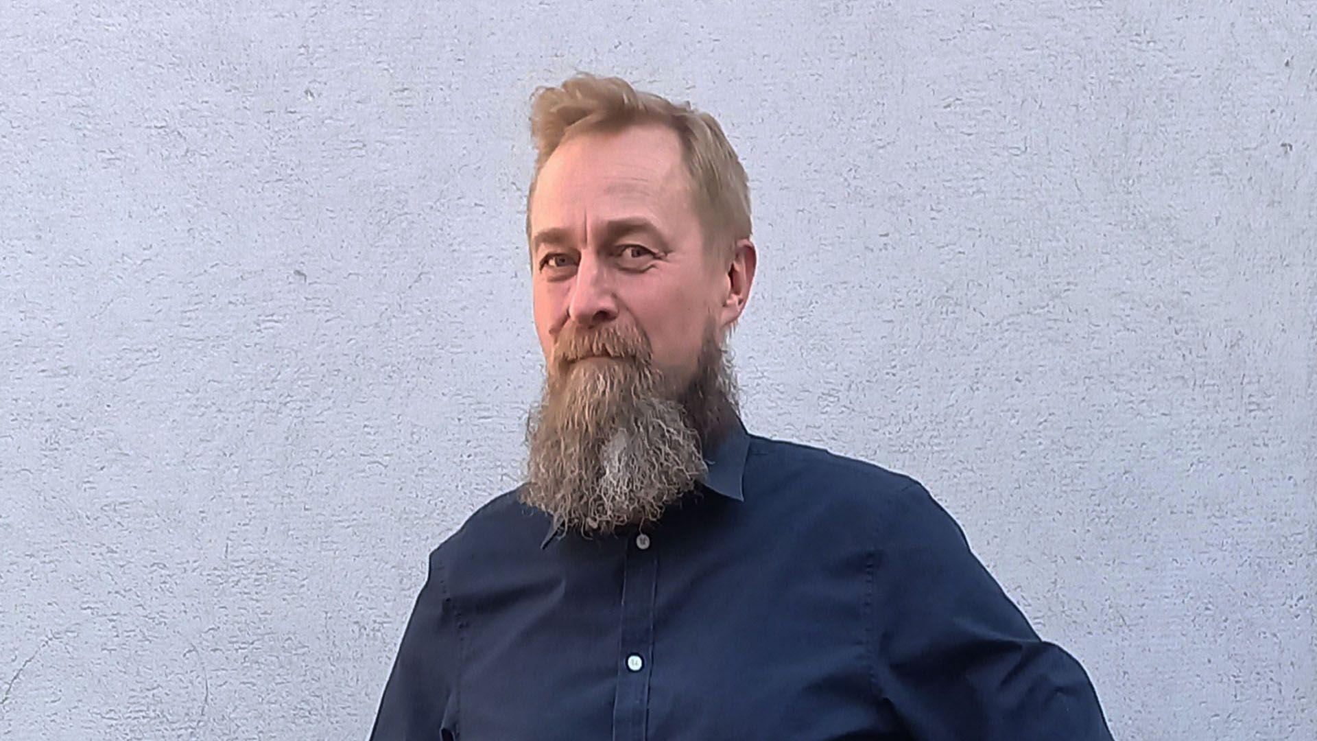 Arve Hjalmar Holmen wearing a dark blue shirt