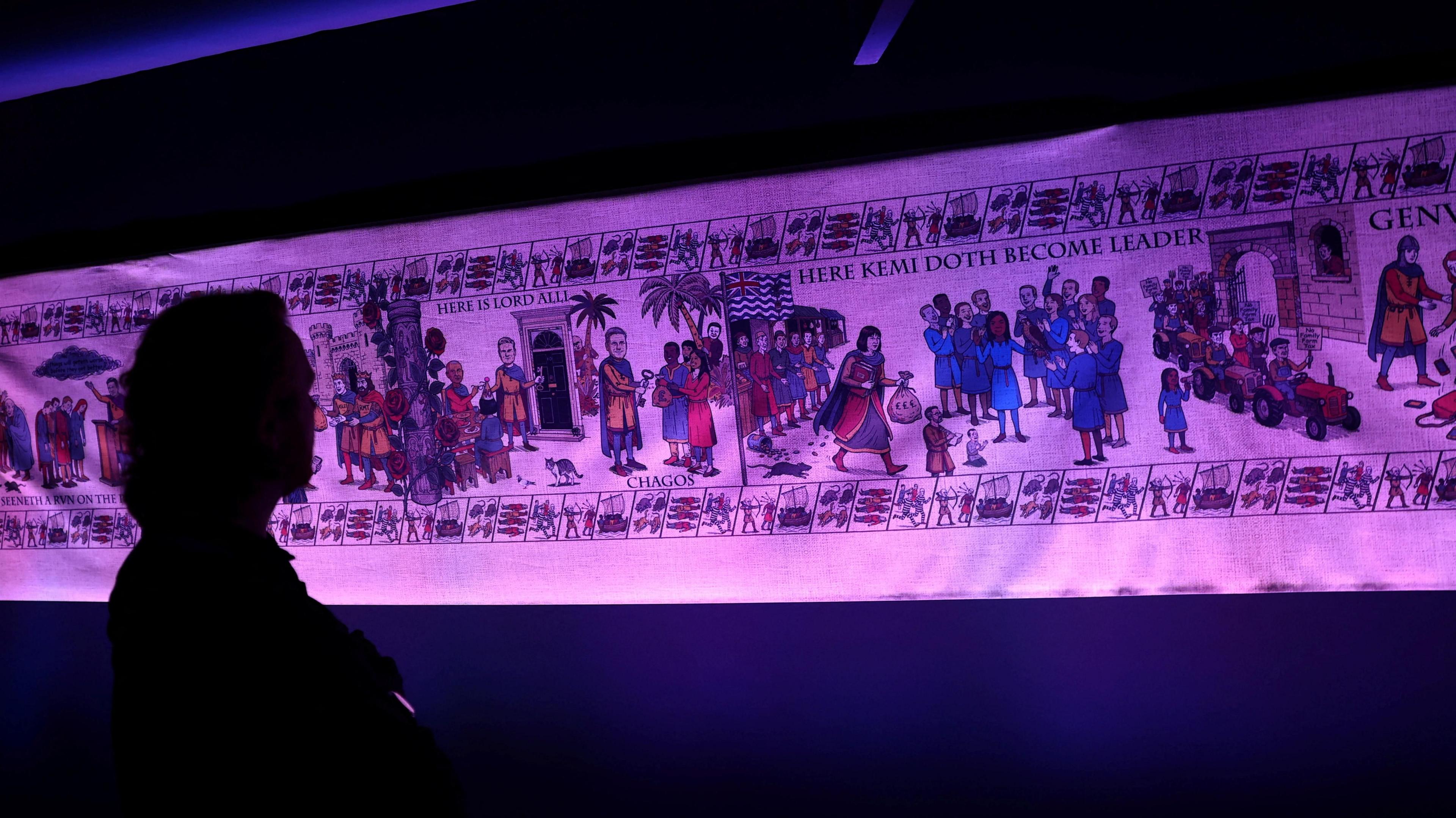 A man in silhouette views the so-called Birmingham Tapestry - an 88 foot depiction of the last two years under Labour, according to the Conservatives. It isa of the last two years under Labour rule, on display at Britain's Conservative Party's annual conference in Birmingham