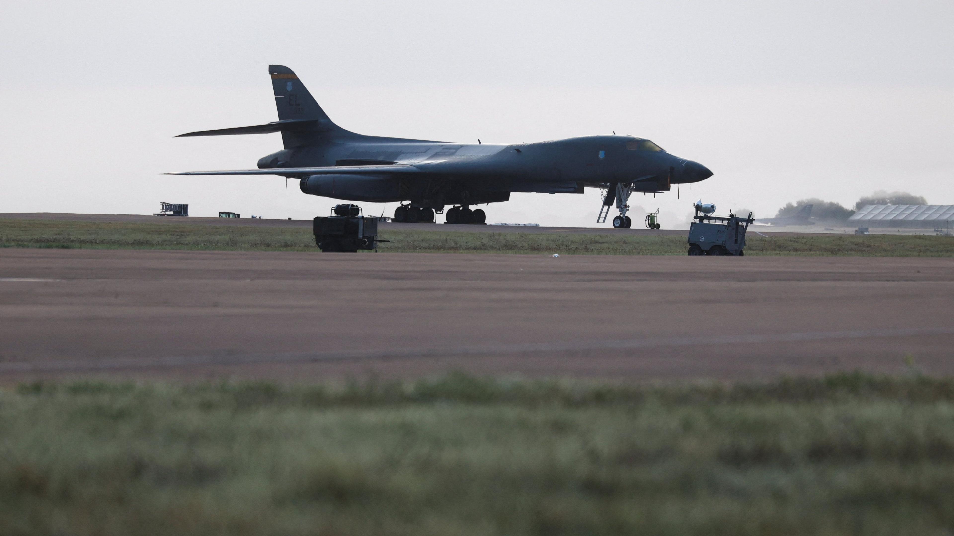 An american bomber sitting on an airfield runway