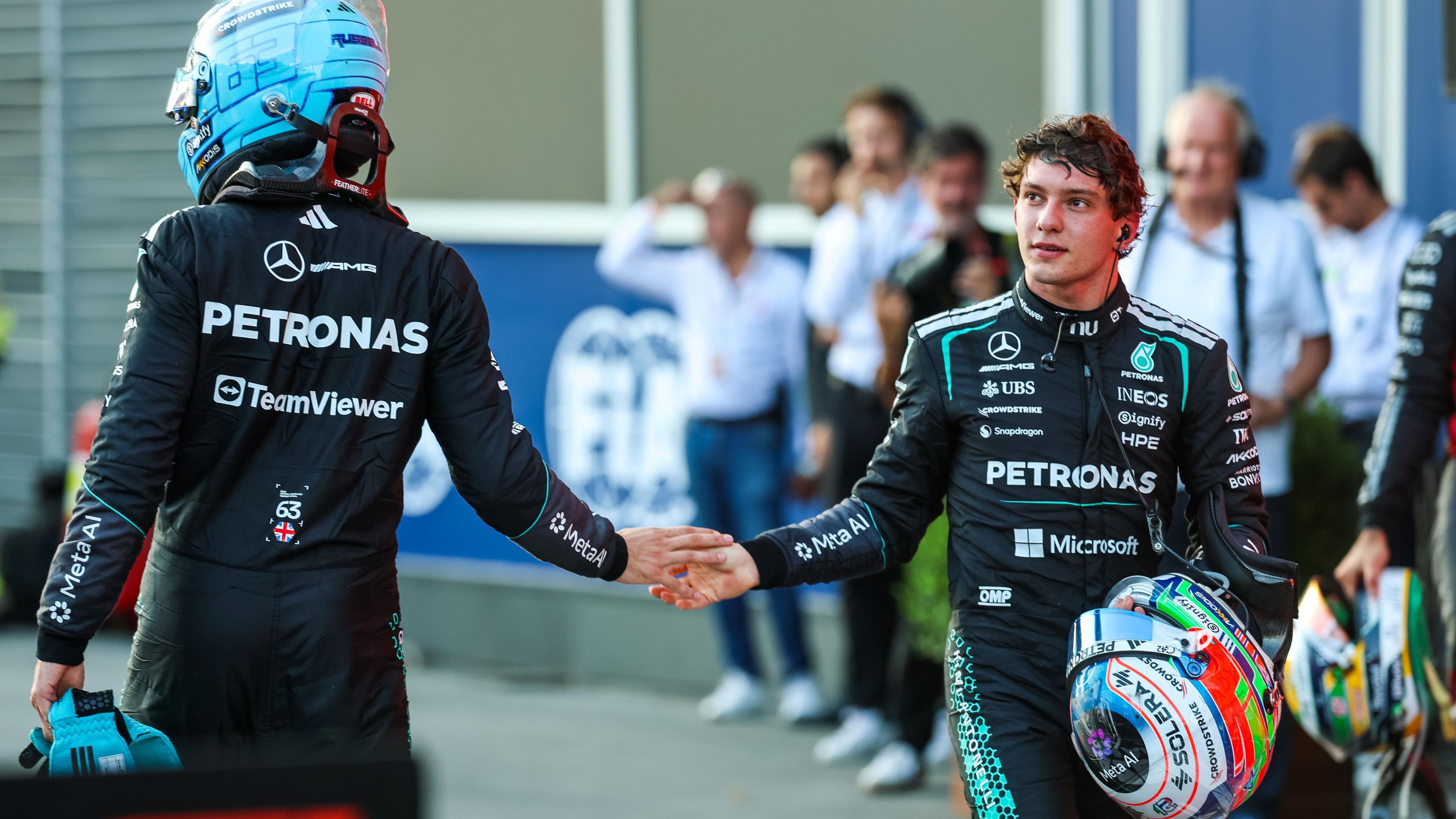 George Russell and Mercedes team-mate Kimi Antonelli brush hands after the Azerbaijan Grand Prix