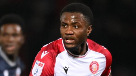 Beryly Lubala in a red and white Stevenage jersey during a match