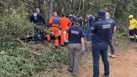 Brazilian police and firefigthers work at the site where a hot air balloon crashed in the southern state of Santa Catarina. Photo: 21 June 2025