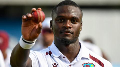 West Indies fast bowler Jayden Seales holds up the ball to celebrate taking five wickets against Pakistan
