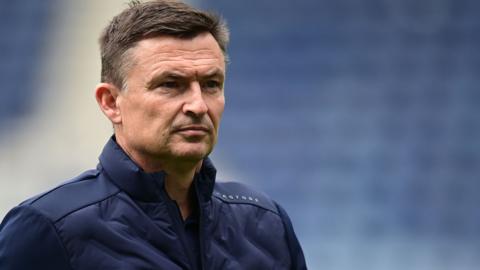 Paul Heckingbottom, wearing a navy blue jacket