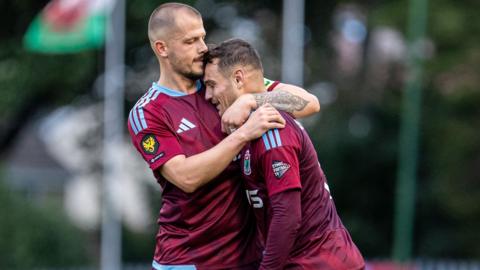 Colwyn Bay's players celebrate after scoring against Connah's Quay.