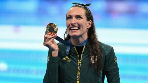 Tatjana Smith holding her gold Olympic medal at the Paris 2024 Olympic Games