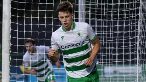 Rory Holden wheels away in celebration after scoring TNS' winner against Llandudno.