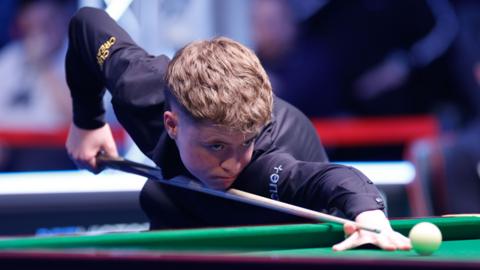 Stan Moody plays a shot