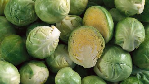 A bowl of Brussels sprouts with one cut in half