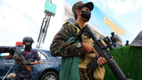Houthi troopers stand guard during a protest against Saudi Arabia, in Sana'a, Yemen.