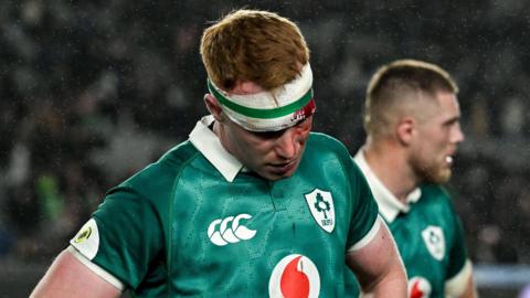 Ciaran Frawley looks to the ground after Ireland's loss against New Zealand