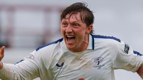 Dom Bess celebrates taking a wicket with his mouth open