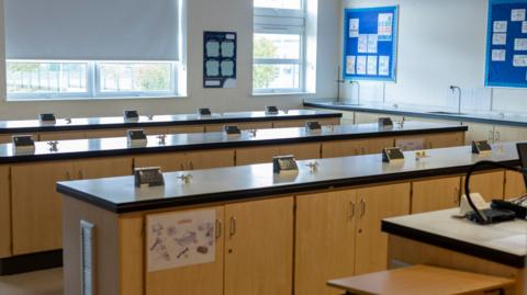 A school science lab with benches and desks