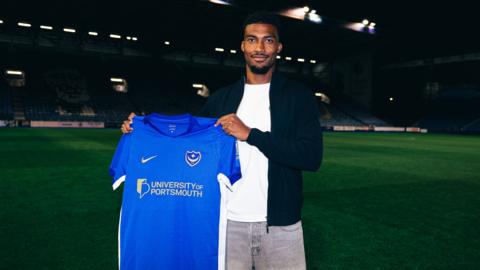 Tyrese Shade poses for a photo after signing for Portsmouth