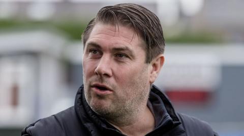 Huw Griffiths looks on from the touchline